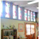 Showing some of the hand-painted wine bottles that are for sale and more of the stained-glass windows