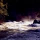 The Merced River illuminated at night. View from our patio.