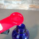 Pouring glycerin into a bottle.