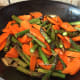 Stir fried asparagus with carrot slices.