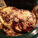 Enchiladas stacked and ready to "bake" in the slow cooker.