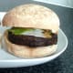 Roll tops are closed over burgers and pickled salad