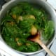 Wilted spinach is stirred through potatoes