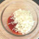 Chopped onion is added to spicy sauce