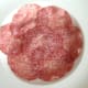 Salami slices bed for salad