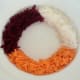 Grated turnip, beetroot and carrot are arranged on serving plate