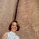 Photo of my niece standing in front of some petroglyphs