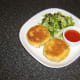 Fish cakes are plated and ready to be garnished for service