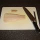 Cod tail fillet is trimmed for frying