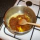 Balti curry paste is added to the softened onion and garlic