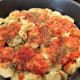 Add half of the vegetable-herb mixture on top of the potatoes.