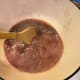 The red wine deglazes the pan. This means that all the little bits that were stuck to the bottom of the pan are lifted back into the sauce, this adds a ton of flavor.