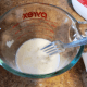 Beat 1 egg into 1/2 cup of milk.