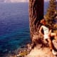 My niece resting against a tree trunk on the steep hike down to the lake