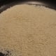Place the raw sesame seeds in the pan