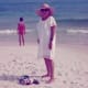 My mother walking on the white sand