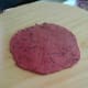 2. Take a small portion of the dough and roll it into a small disc.