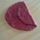 3. Add a little ghee on the disc and fold about one-third of it over.