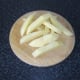 Potato slices are chopped in to chip shapes