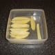 The once fried chips are returned to the plastic dish and the fridge