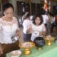 Laddling the rice on Pchum Ben