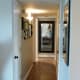 The placement of this mirror reflects right back into the living area. This is a great use of a mirror in a hall to affect feng shui energy.