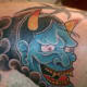 A blue hannya mask tattoo.