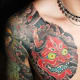 A red hannya mask tattoo.