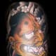 An orange hannya tattoo.