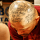 Text tattooed on scalp.