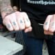 "Read more" knuckle tattoos.