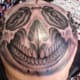 a face tattooed on a person's head