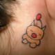 a little animal tattooed behind a person's ear