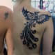 A coverup tattoo on a small pattern with a tribal phoenix.