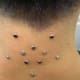 An Inverted Star-Shaped Nape Piercing