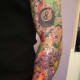 A colorful eight ball arm tattoo.