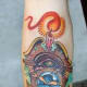 Vivid grandfather clock tattoo.