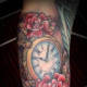 Clock tattoo with roses.