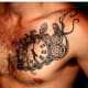 Clock tattoo with gears.