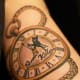 Pocket watch tattoo with text.