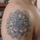 Tattoo of the inner workings of a clock.