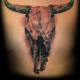 A dark skull tattoo on a chest.