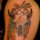 A colorful skull with feathers.