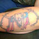 Skull and American flag surrounded by barbed wire.