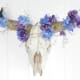 A bull skull with flowers and pearls: strength and beauty.