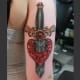 Knife through broken heart arm piece