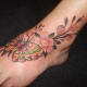 Feminine butterfly and flowers tattoo