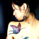 Butterfly tattoo on shoulder of woman