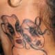 This tattoo features an elegant pair of masks.