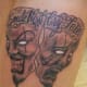 Another "smile now, cry later" tattoo in a similar style.
